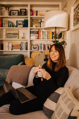 Amy, sitting and enjoying a warm cup of tea